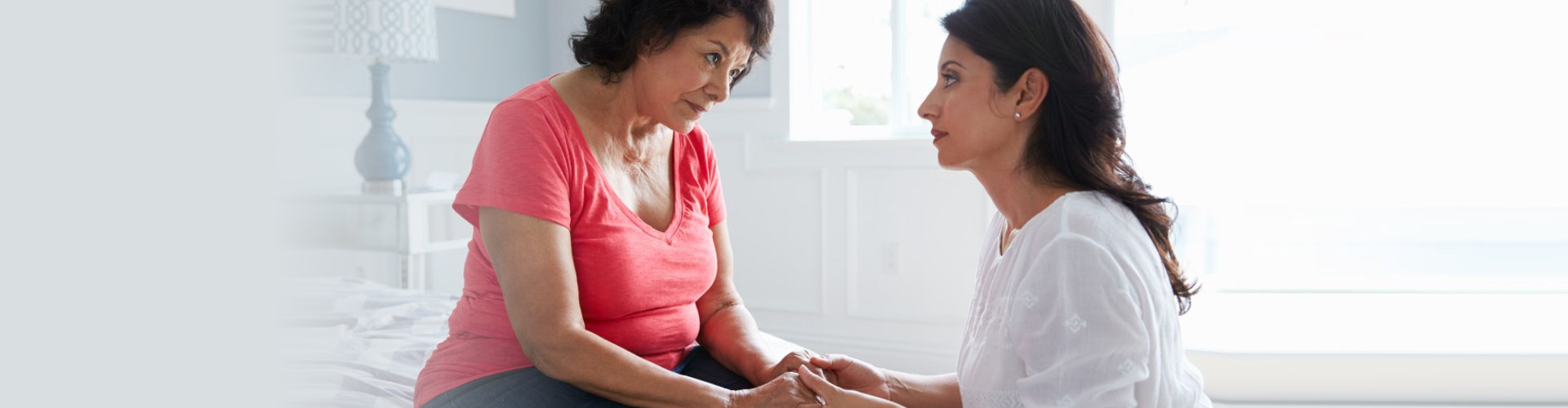 caregiver comforting a senior woman